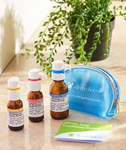 Three Allergychoices allergy drop bottles beside a branded carry pouch and an allergy drop treatment record.