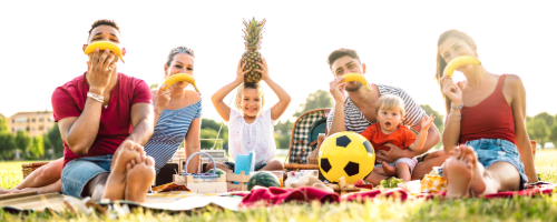 A family picnic outdoors with food